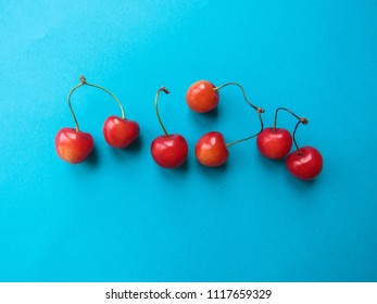 red cherry on a blue table