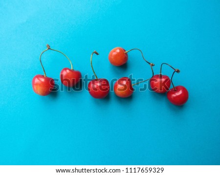 red cherry on a blue table