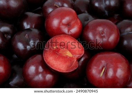 Red cherry plums as background