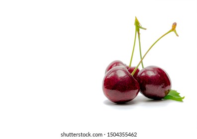 Red cherry with stalk and leaf isolated on white background. Ripe red sweet cherry. Sweet and juicy organic cherry. Fresh fruit for summer dessert. Raw material for jam industry. Antioxidant food.