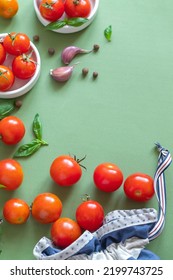 Red Cherry Tomato In Textile Bag, Green Basil, Purple Garlic Cloves, Pepper On A Green Background. Top View. Copy Space. Zero Waste. Eco Friendly Shopping.