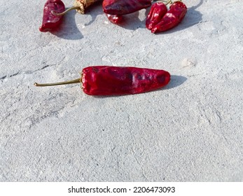 Red chili Cayenne pepper are scattered on the ground. Red dry chili or chili Cayenne pepper as a food background. smoked dry red paprika spicy. Hot red chili pepper. Close up capture