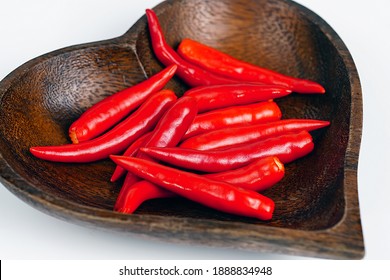 Red Chili In Heart Shaped Wooden Bowl.