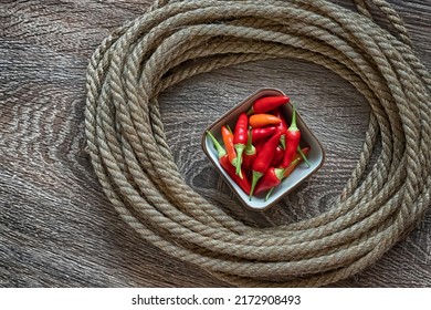 Red Chili Peppers, Fresh Vegetables In A White Plate In The Center Of A Rope Circle