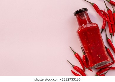 Red chili sauce ketchup or tabasco with ripe hot pepper.