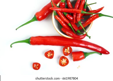 Red Chili In Yellow Cup And Chilli Peppers Cut Into Pieces Isolated On A White Background.