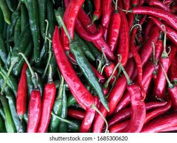 Red Chilies And Green Chili Stem For Textured And Background. Spicy Red Tiny Fiery Chili Have Capsicum Oleoresin And Full Of Capsicin Extract. 