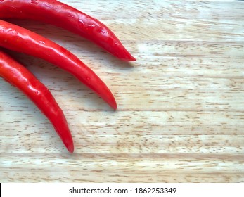 Red Chilli, Cayenne Pepper, Chilli Spur Pepper, Long Fed Pepper, Capsicum Annuum Linn. Var Acuminatum Fingerhut., Long Red Chilli On Wooden Cutting Board