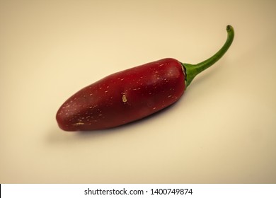 A red chilli on a white backdrop. 