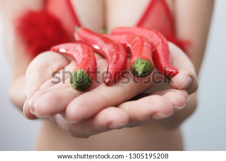 Red chilli peppers in female hands