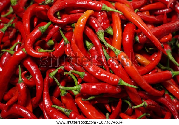 Red\
Chillies Background, Selective focus. red Chili is a vegetable that\
is spicy and popular in Asia. Top View Pile of Fresh Chili for Sale\
in The Market. Template to mock up or input\
Text.