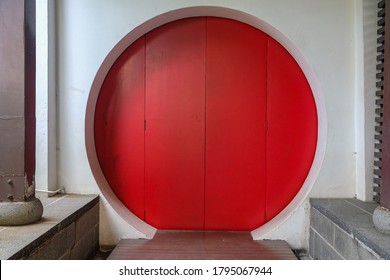 A Red Chinese Circle Door In China Town In Singapore.