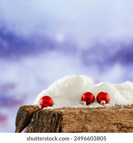 Red christmas ball on snow on wooden board with blurred snow falling and shimmering background.  - Powered by Shutterstock