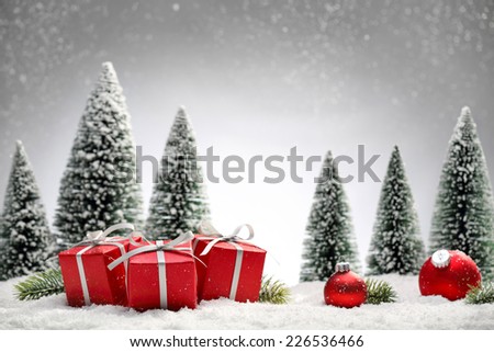 Red Christmas balls,gift boxes and fir tree on snow