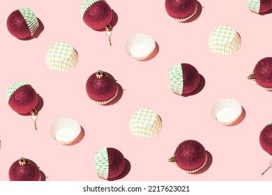 Red Christmas Baubles In Green Square Pattern Cupcake Liners, Creative Winter Holidays Layout, Candy Pink Background. 