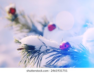 Red Christmas bell hangs on a snow-covered branch of a Christmas tree against a festive background of white snow and golden bokeh lights with copy space. New Year, greeting and holiday card, banner. - Powered by Shutterstock