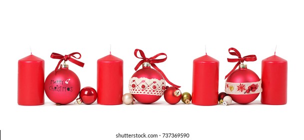 red Christmas candles with red Christmas balls isolated on white