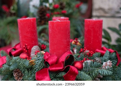 red Christmas candles with decoration in the flower shop outdoors