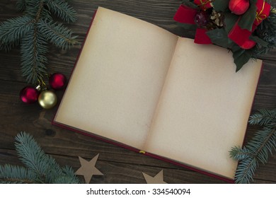 Red Christmas Decorations And An Open Book On The Table