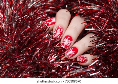 red Christmas manicure with deer and snowflakes and Norwegian pattern - Shutterstock ID 780309670