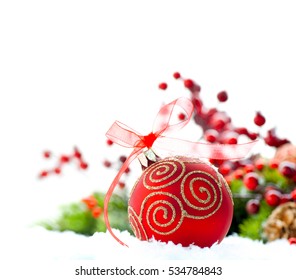 Red Christmas and New Year Decoration isolated on white background. Border art design with holiday bauble. Beautiful Christmas tree closeup decorated with ball, holly berry. Space for your text.