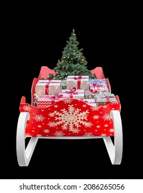 Red Christmas Sleigh With Gifts Boxes And Christmas Tree On A Black Background Isolated, Front View, Close-up. 