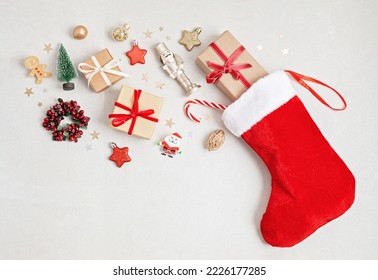 Red Christmas stocking with gifts and decoration. Traditional Xmas celebration concept - Powered by Shutterstock