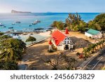 Red church at Cap Malheureux village, Mauritius Island. Notre Dame de Auxiliatrice, rural church with red roof in Cap Malheureux tropical village on Mauritius island, Indian Ocean.