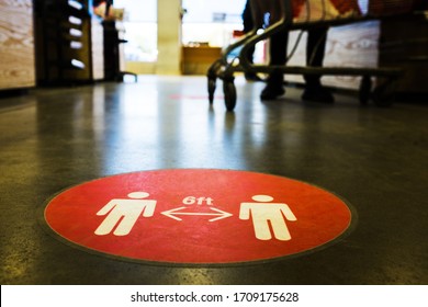 Red circle symbol sign printed on ground at US supermarket cash register cue informing people to keep 6 feet distance from each other to prevent spreading Coronavirus COVID-19 virus disease infection - Shutterstock ID 1709175628