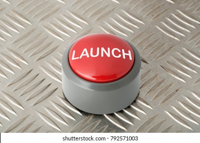 Red circular launch push button on an aluminum diamond plate background