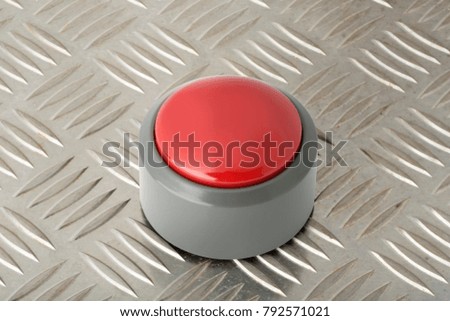 Red circular push button on a steel diamond plate background