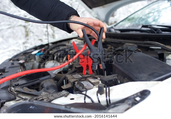 red clamp on car battery. for charging\
battery car with\
electricity