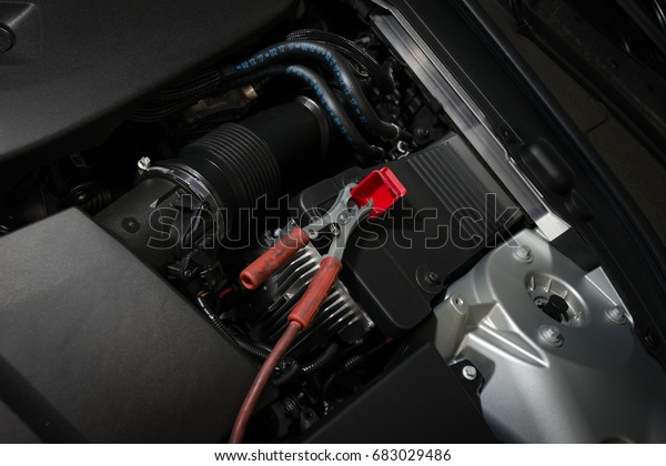 red clamp on car battery for charging battery car with\
electricity. 