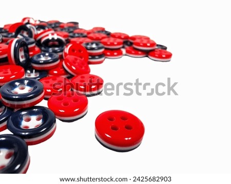 Red clasper , colored plastic buttons isolated on white background 
