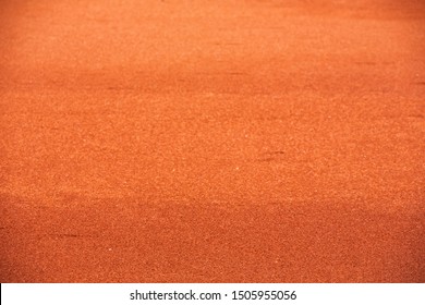 Red Clay Court Tennis Background Texture. Tennis Court Close-up Of Gravel Surface. Seamless Texture.