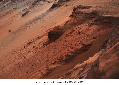 Red clay quarry. Clay quarry. Top view of a sand excavation site. Earth rocks are digging for building materials. Beautiful natural landscape to the land. Quarry with sand, sand loading, ground water,