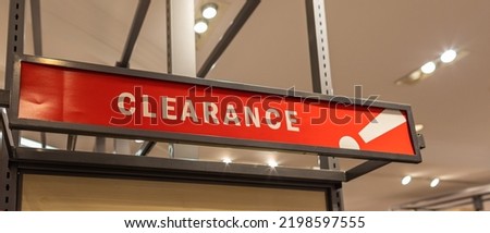 Red clearance sale sign in retain store. Sale signs in a clothing store. Nobody, selective focus