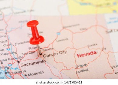 Red clerical needle on a map of USA, Nevada and the capital Carson City. Closeup Map Nevada with Red Tack