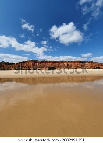 Red Cliffs Reflected on Praia da Falésia Beach, Algarve, Portugal