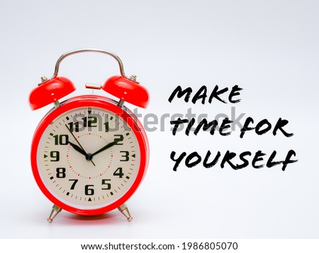 A red clock isolated on a white background with phrase 