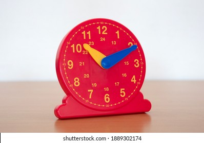 Red clock in a primary school - Learning children how to tell the time on clock - Powered by Shutterstock - Get 15% off with code: PIKWIZARD15