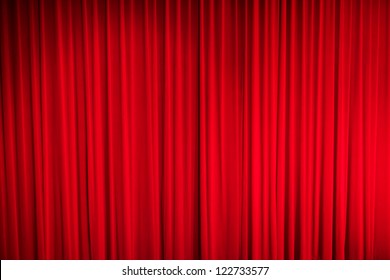 Red closed curtain with light spots in a theater - Shutterstock ID 122733577