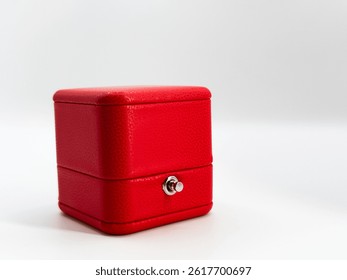 Red closed rectangular leather wedding ring box on white background front view. High quality photo