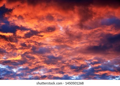 Red clouds at sunset, fire on black background