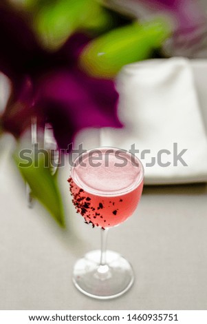 Red cocktail decorated with dried fruits at a restaurant