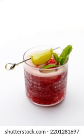 Red Cocktail, Rasberry Mojito, A Long Drink In A Glass, With Ice Cubes, Rasberries, Garnished With Mint Leaves And Lemon, Isolated On White Background, Selective Focus.