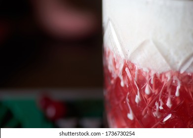 Red Cocktail Standing On A Bar Mat Close-up In Macro With The Stains A Place In The Tex