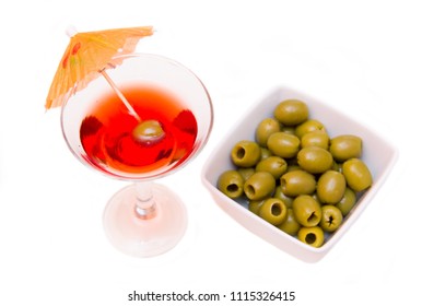 Red Cocktail With Umbrella And Olives On A White Background Seen From Above