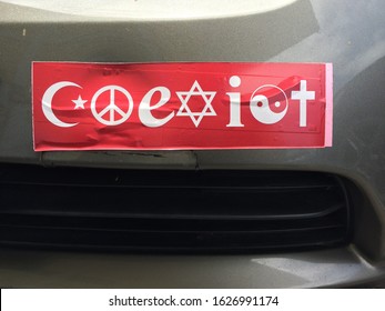 Red Coexist Bumper Sticker On Car Parked