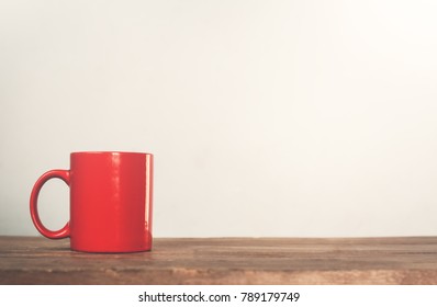Red Coffee Mug On A Wood.